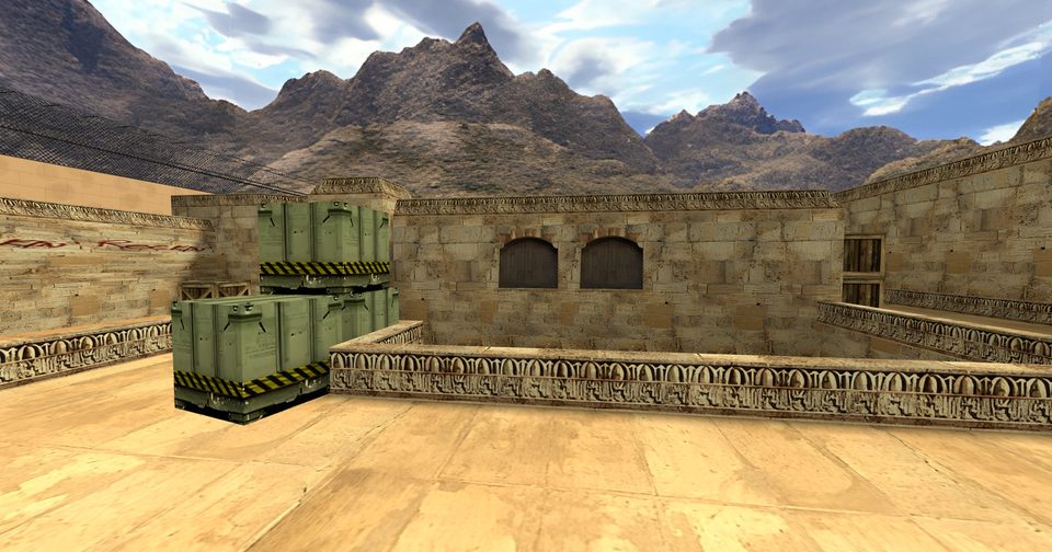 El sitio A de de_dust2 en Web Strike: cajas verdes, muros de piedra y montañas al fondo